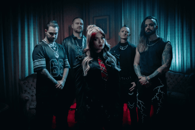 Five-member rock band in a moody blue/red-lit room; woman with blonde hair stands center front, others behind.