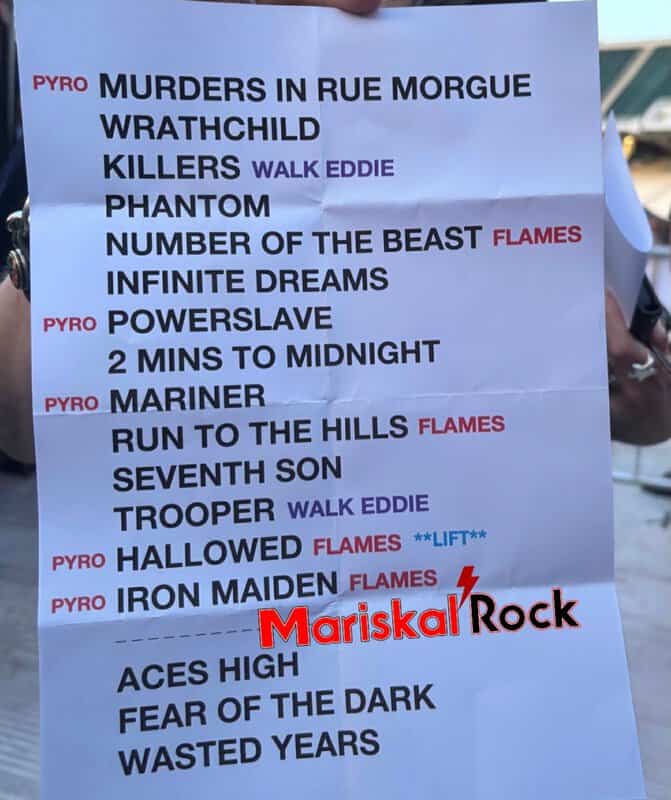 Printed sheet listing a long lineup of band names for an event, with several words highlighted in red or purple (e.g., PYRO labels and Flames/WALK EDDIE), and a Mariskal Rock watermark at the bottom.