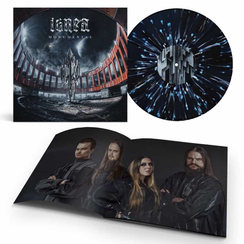 Album cover art for Lorna: Monumental, with a circular ruined arena under a starry sky, a blue speckled vinyl record, and a folded band photo booklet showing four members.