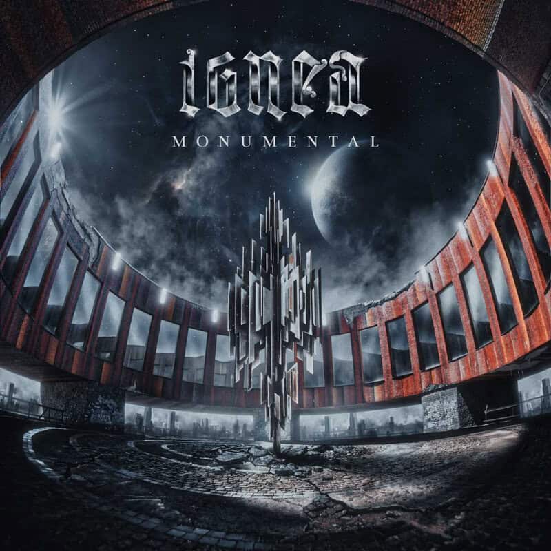 Album cover showing a circular brick arena with a central geometric metal monument and a space backdrop featuring a large planet; title Monumental at top.